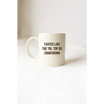 White mug with black text from the Tastes Like TRL Top 20 Countdown, perfect for stylish moms