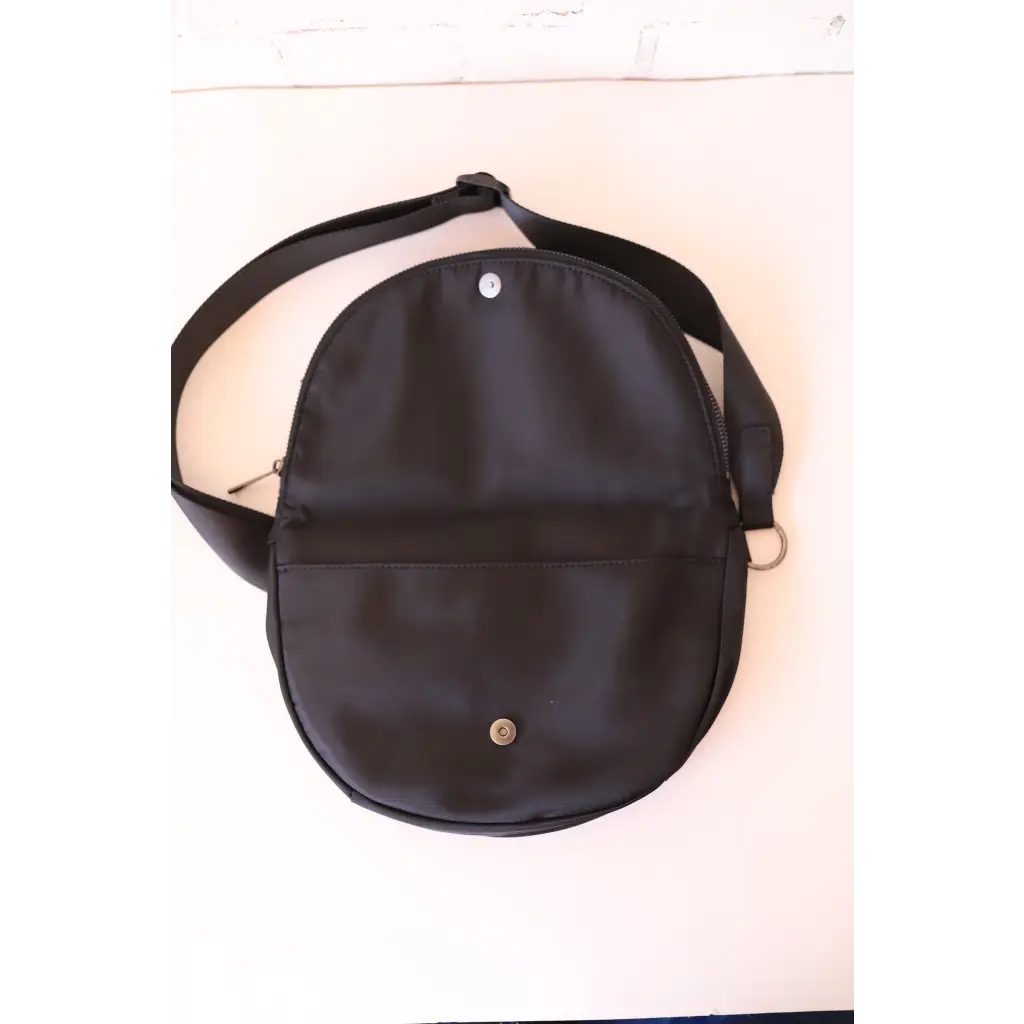 Open black crossbody bag from The Adventure Crossbody Bag perfect for stylish womens clothes