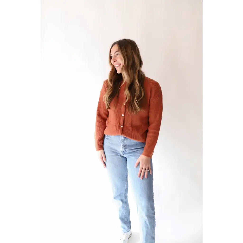 Rust-colored Annie Cardigan Sweater styled with light wash jeans for a chic look