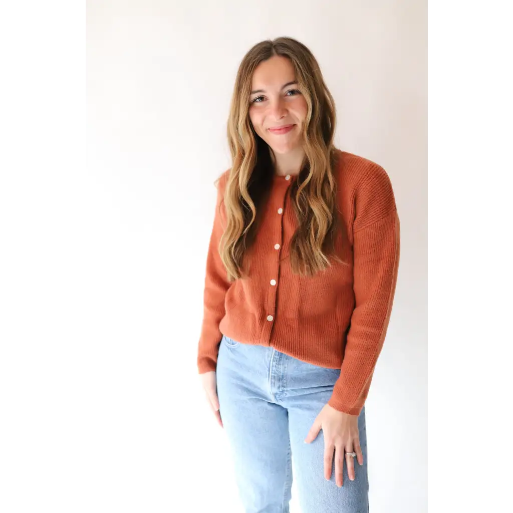 Rust-colored Annie Cardigan Sweater styled with light wash jeans for a chic look