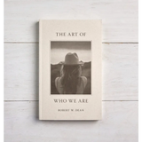 Book The Art of Who We Are by Robert W. Dhan with stylish black and white cover art