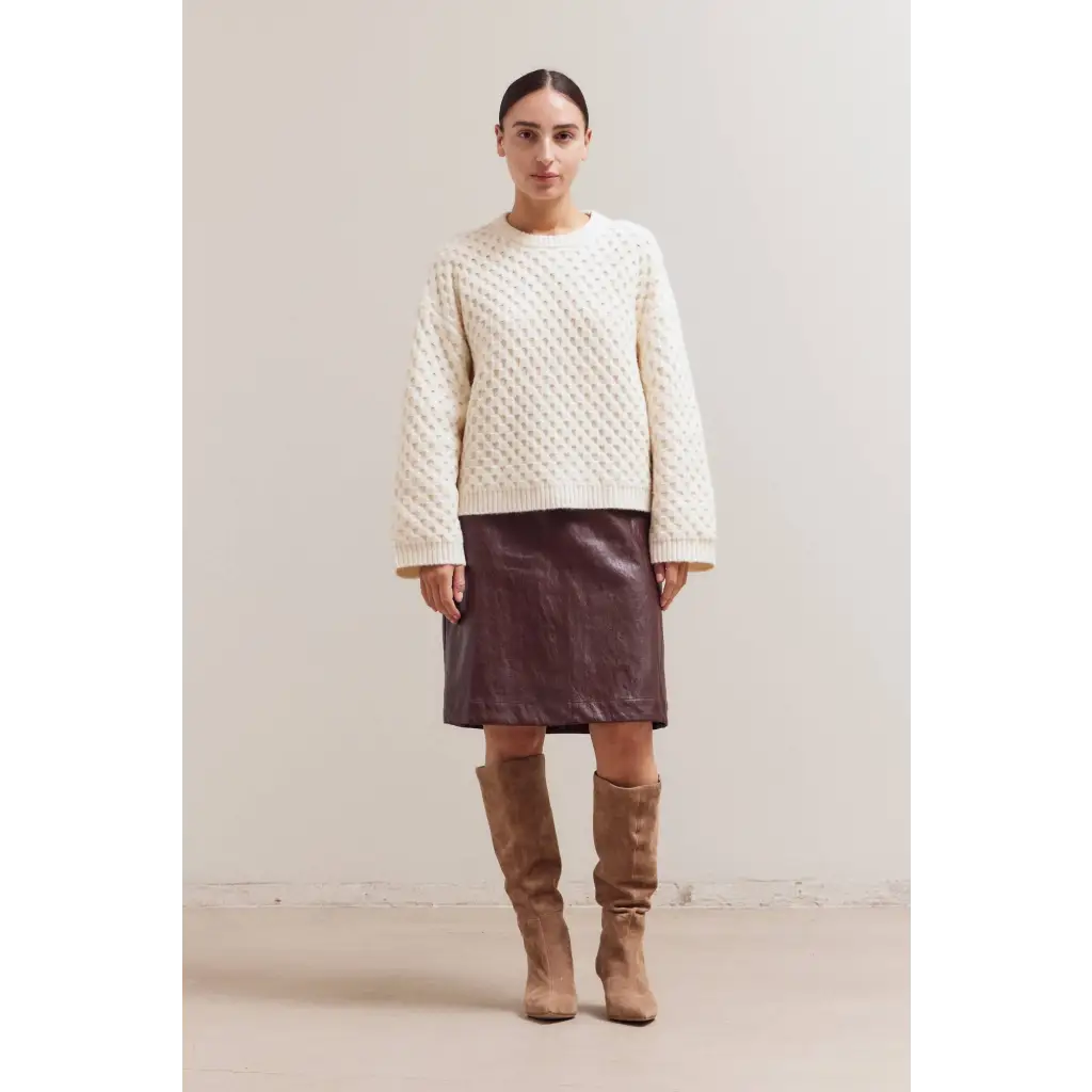 Cream Betsy Crew Knit sweater with brown leather skirt and tan boots
