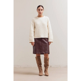 Cream Betsy Crew Knit sweater with brown leather skirt and tan boots