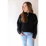 Black Brandi Contrast Sweater with cool white stitching details along the sleeves