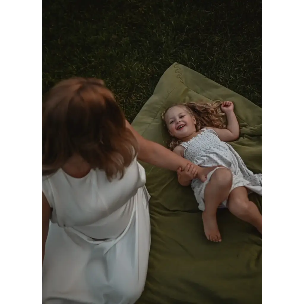 Parent and child enjoying a joyful moment on a Cozy Premium Organic Cotton Blanket