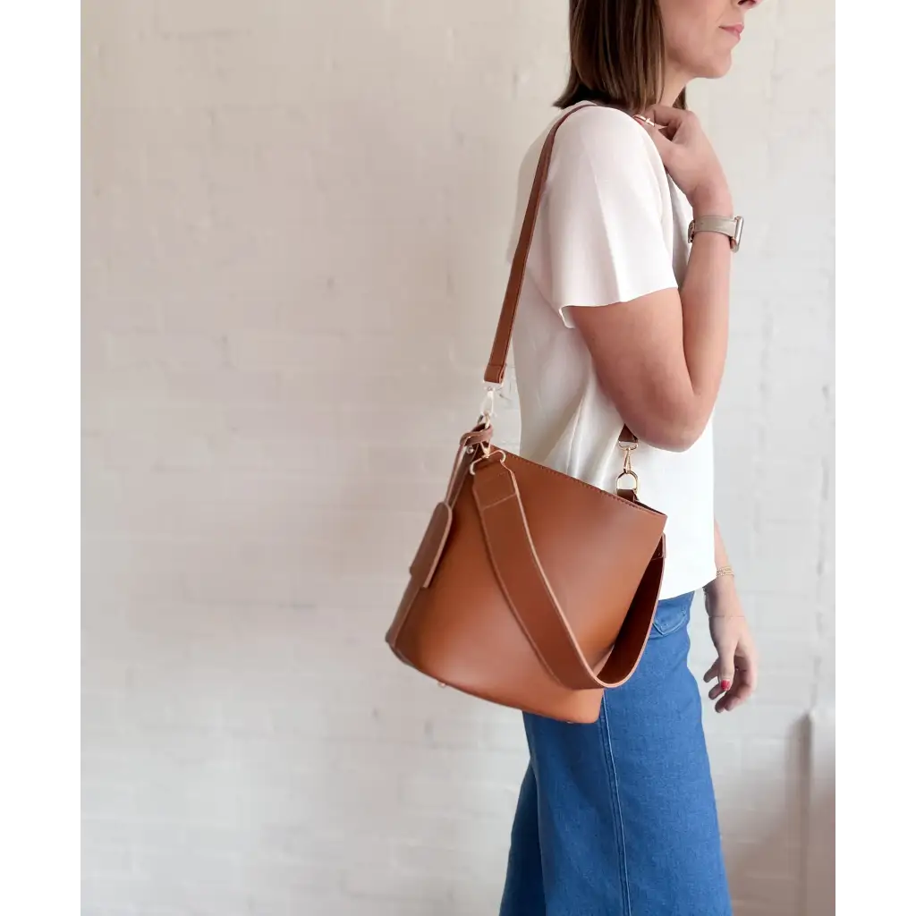 Brown leather bucket bag styled with The Deanna Top short-sleeve knit tee