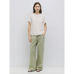 Woman in beige t-shirt and green pants, perfect stylish womens clothes for moms