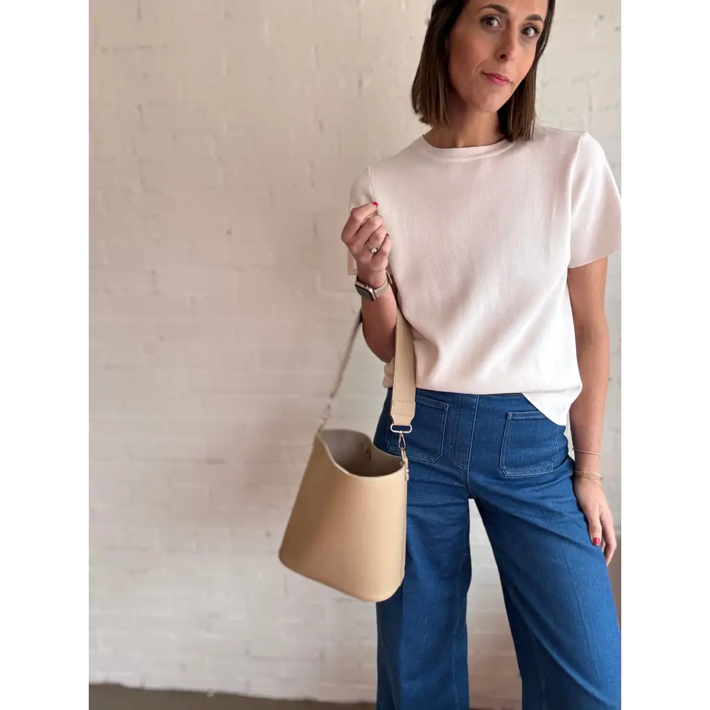 Woman rocking a beige bucket bag with The Deanna short-sleeve knit tee