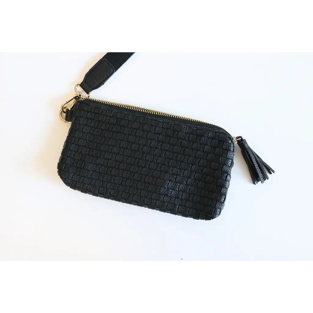 Stylish Devin Clutch in solid black with woven leather, zipper, and tassel detail