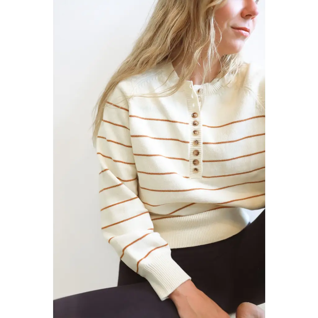 Cream-colored Ellen Henley Sweater with stripes and decorative buttons for classic style