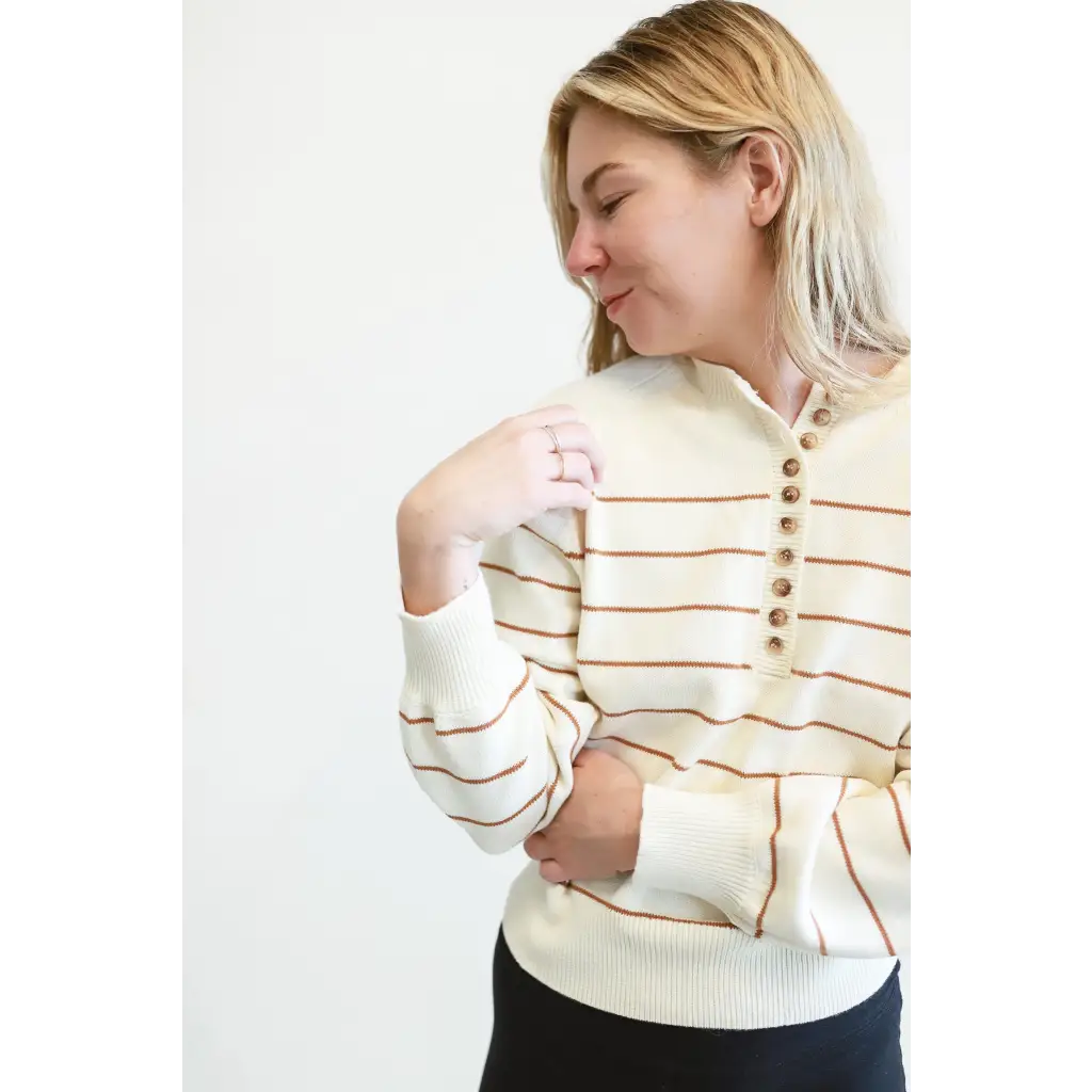 Cream-colored Ellen Henley Sweater with brown stripes and stylish decorative buttons