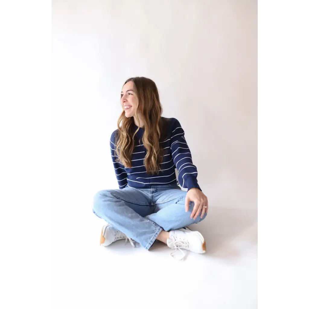 Navy and white striped sweater paired with light blue jeans and sneakers, perfect for Peace Signs Camp