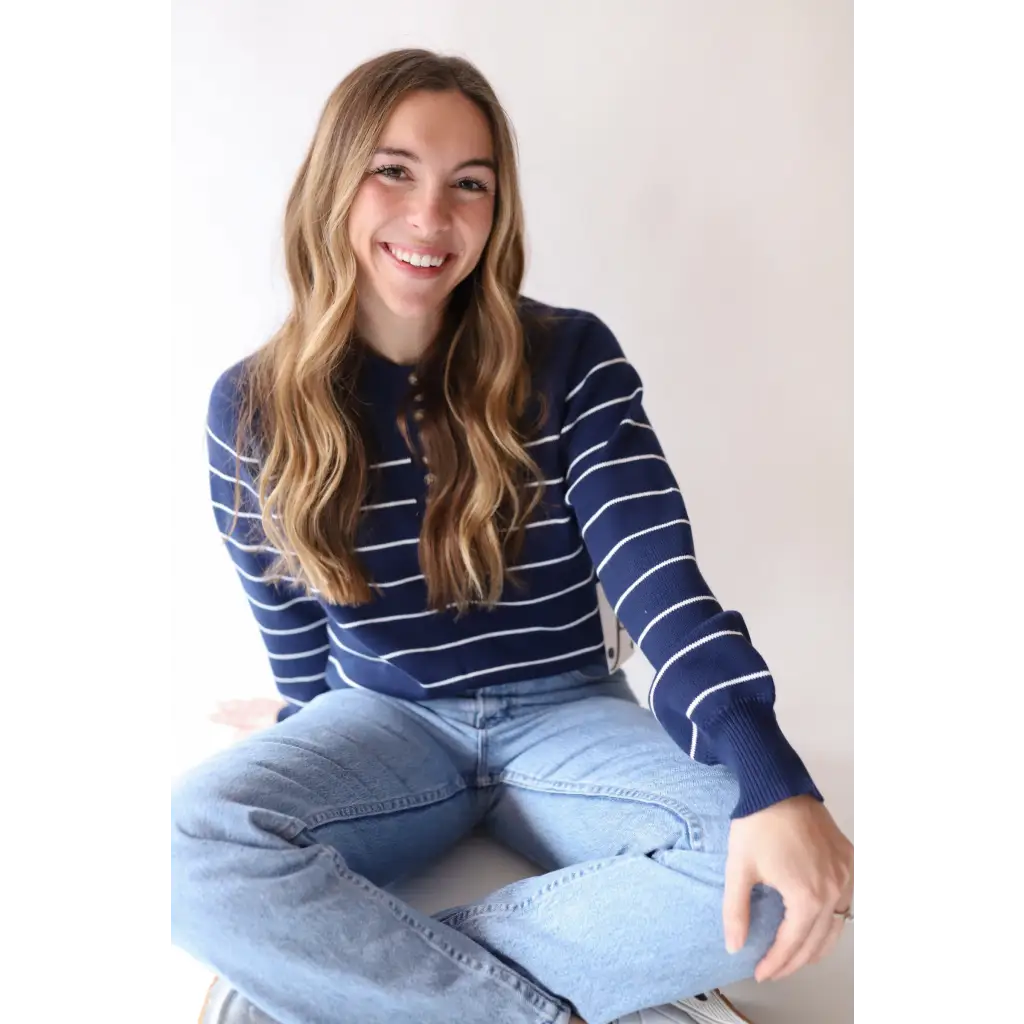 Smiling person in The Ellen Henley Sweater with three peace signs for signs camp vibe