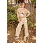 Beige weekend sweater with llama design, paired with cream tracksuit pants and white boots