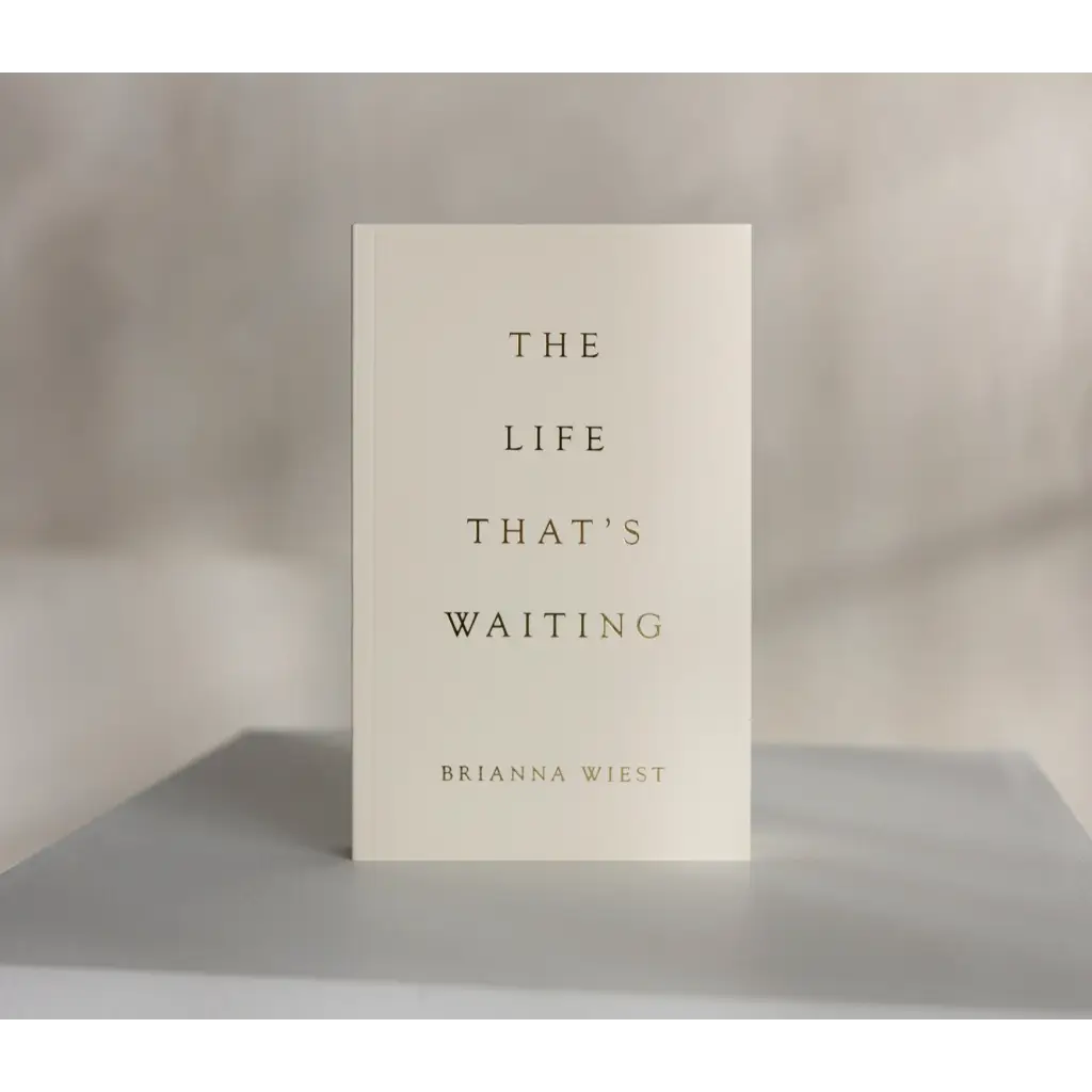 White book titled The Life That’s Waiting by Brianna Wiest with minimalist cover design
