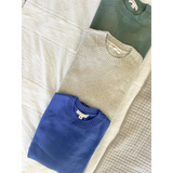 Three Margo Crew Neck Sweaters in blue, beige, and dark green with ribbed details