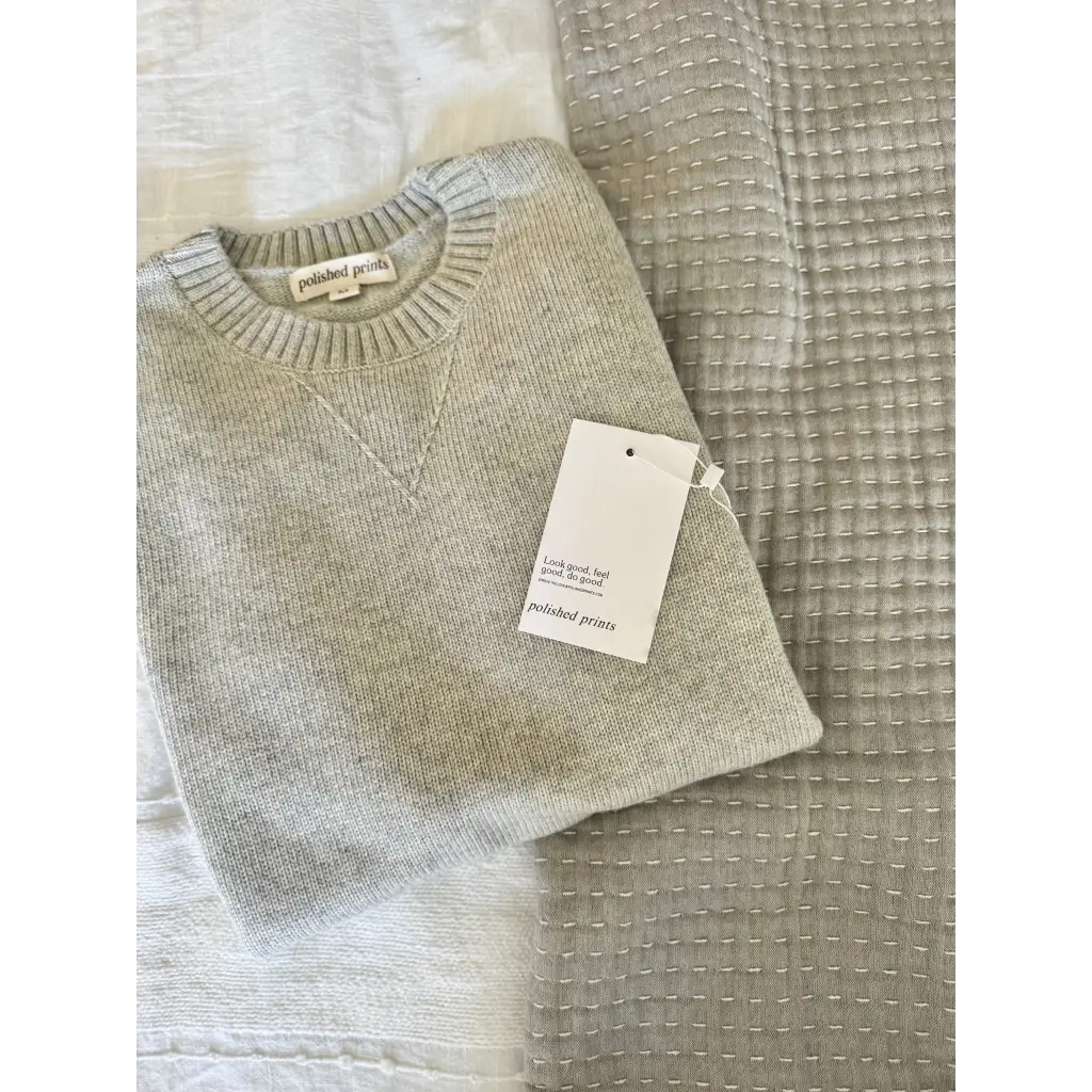 Light gray Margo Crew Neck Sweater with price tag showing ribbed details