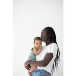 Parent wearing a mom crop boxy tee holds a baby in a mint green outfit