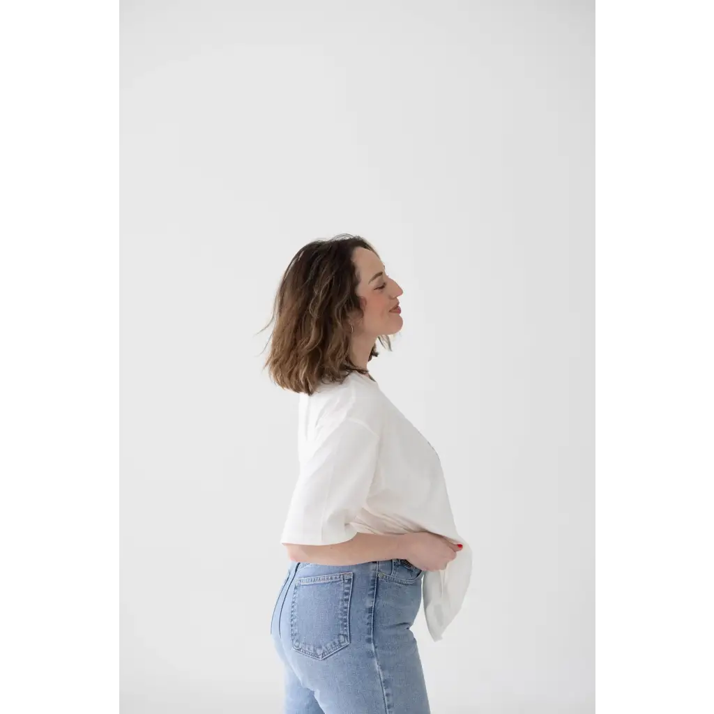 Side profile of mom wearing Stylish Mom Crop Boxy Tee and light blue jeans