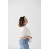 Side profile of mom wearing Stylish Mom Crop Boxy Tee and light blue jeans