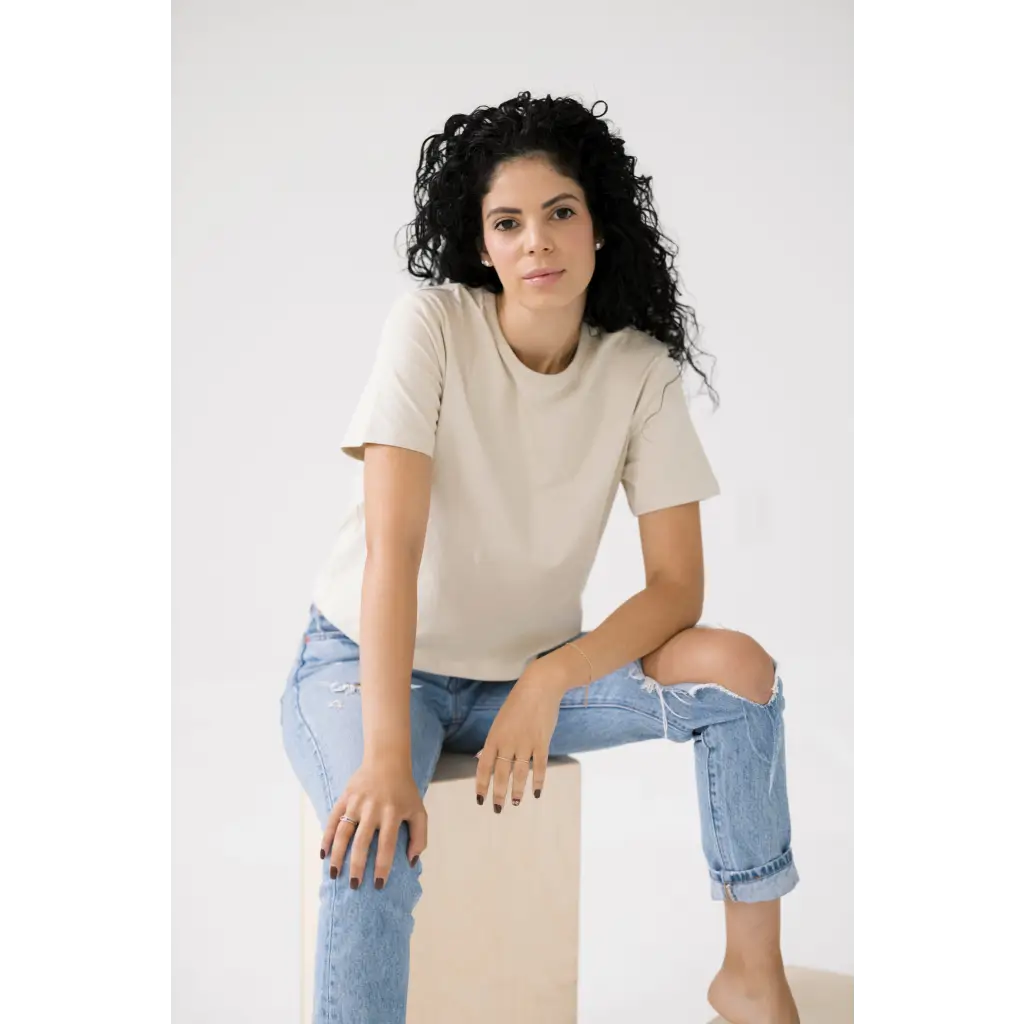 Woman in a cream mom crop tee and distressed jeans for a polished look in bone white