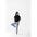 Casual pose in a black mom crop boxy tee and light blue jeans for effortless style