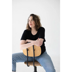 Person in a black shirt and blue jeans rocking a Stylish Mom Crop Boxy Tee on a chair