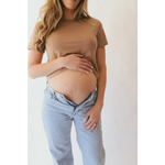 Pregnant woman in The Mom Crop in Mocha, stylish womens clothes with polished prints