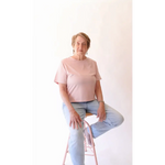 Elderly woman in pink shirt and jeans wearing The Mom Crop in Rose, stylish womens clothes