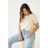 Person in a cream mom crop boxy tee and light blue jeans for casual vibes