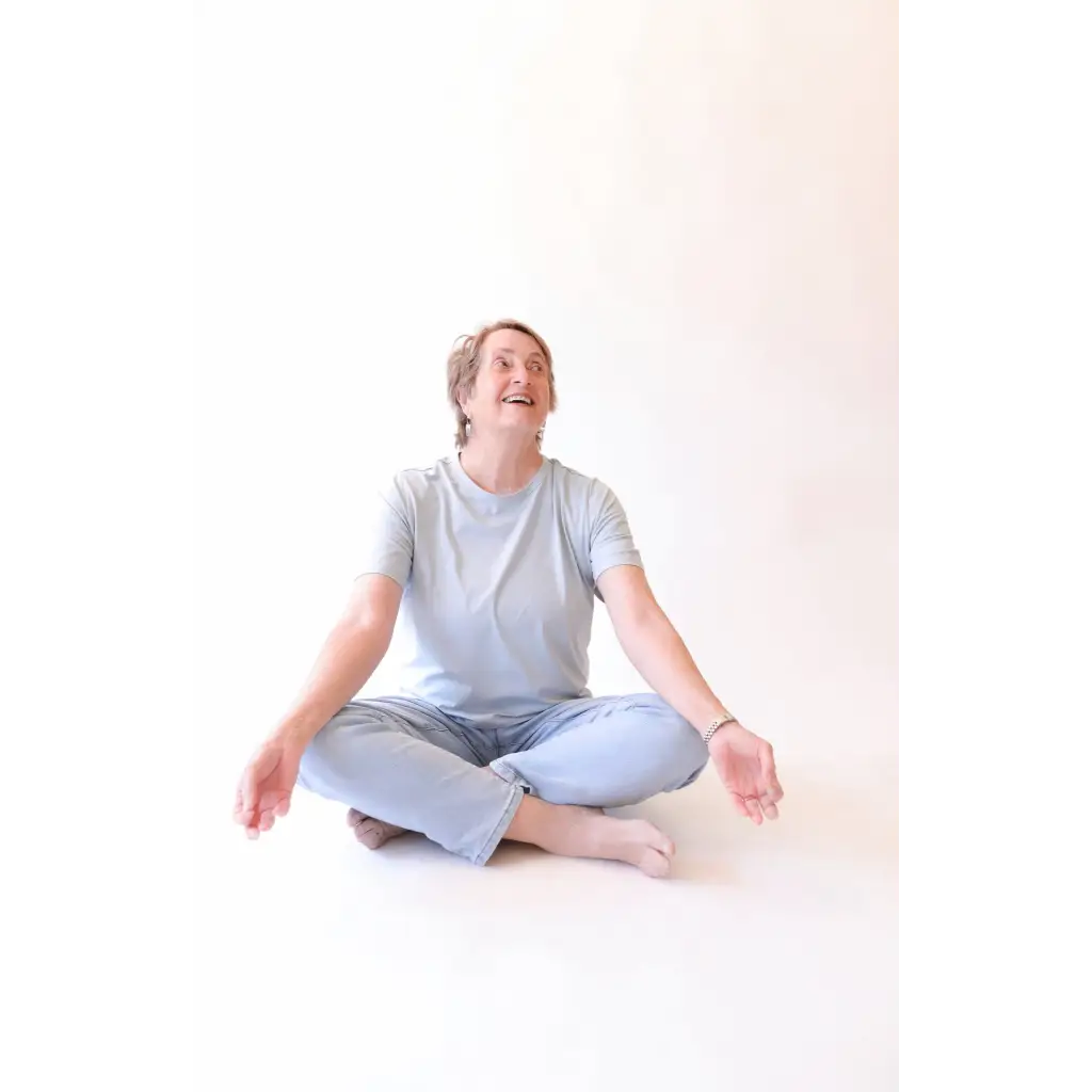 Person sitting cross-legged wearing The Mom Crop in Sky from stylish womens clothes