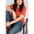 Person in a coral boxy tee designed for comfort, sitting in a chair with jeans