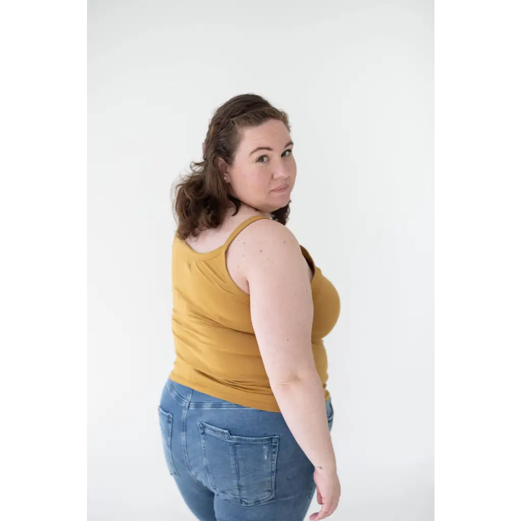 Person rocking a Mustard Yellow Mom Tank Top with blue jeans, perfect for stylish womens clothes