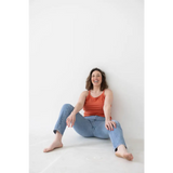 Casual look in a red mom tank and blue jeans, showcasing stylish womens clothes with polished prints