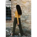 Woman in organic cotton baby rib cardigan with olive trousers