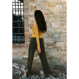 Woman in organic cotton baby rib cardigan with olive trousers