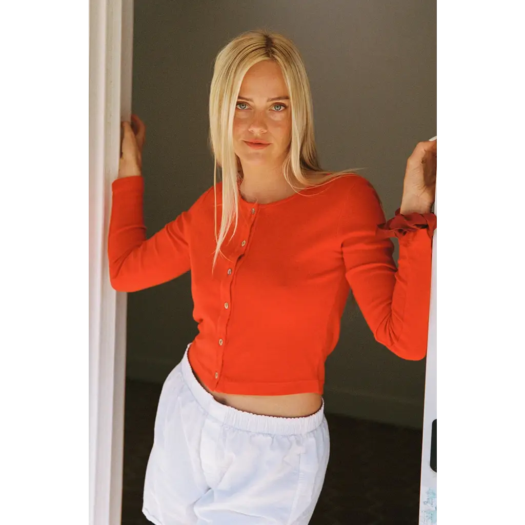 Vibrant orange organic cotton baby rib cardigan crop top with ruffled cuffs