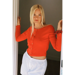 Vibrant orange organic cotton baby rib cardigan crop top with ruffled cuffs