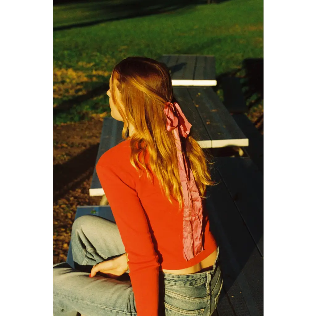 Back view of Organic Rib Cotton Cardigan with pink satin bow at nape