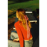 Back view of Organic Rib Cotton Cardigan with pink satin bow at nape