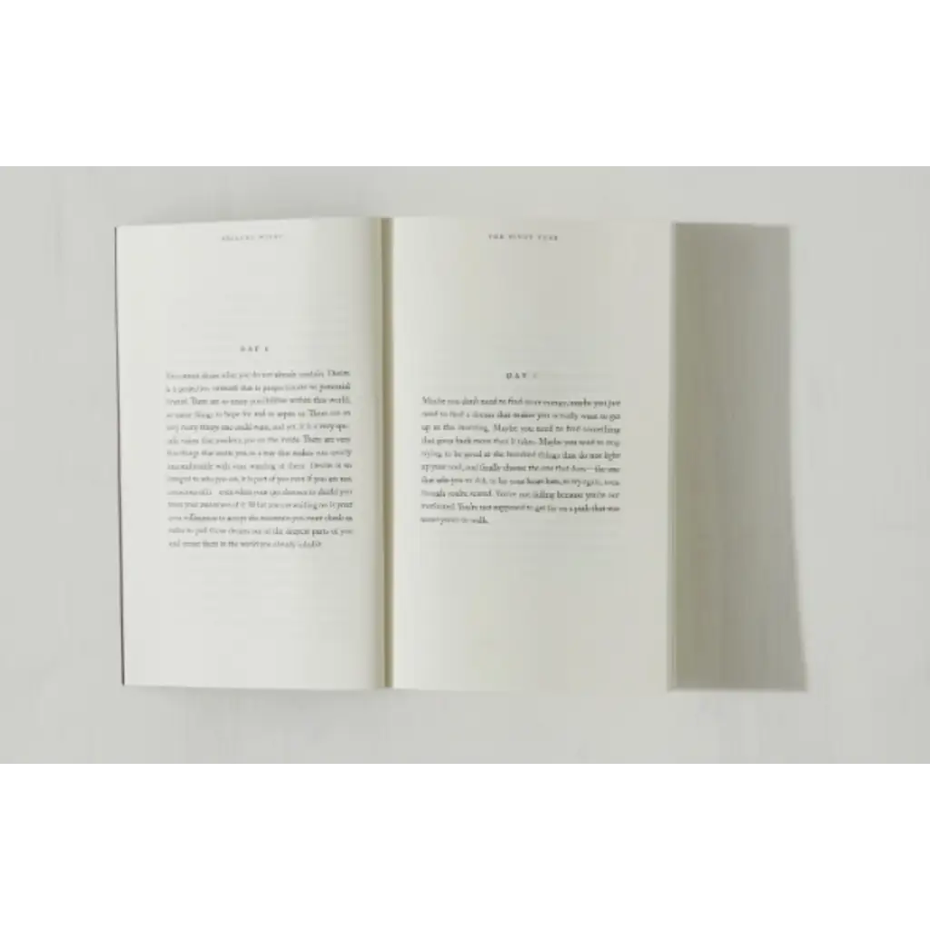 Open book with printed text from Brianna Wiest’s Pivot Year showing polished prints