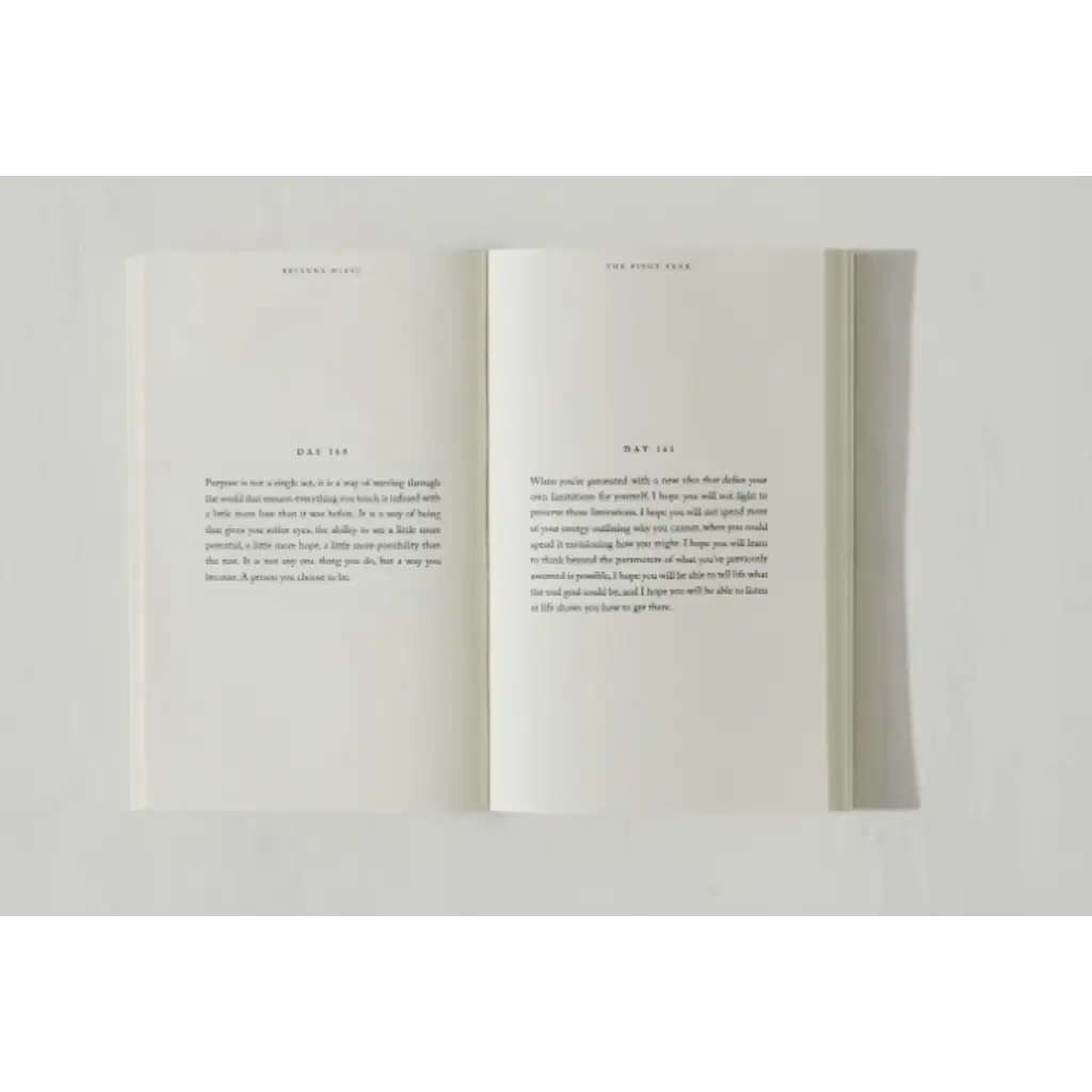 Open pages of Brianna Wiest’s Pivot Year book featuring minimalist text and polished prints