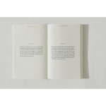 Open pages of Brianna Wiest’s Pivot Year book featuring minimalist text and polished prints