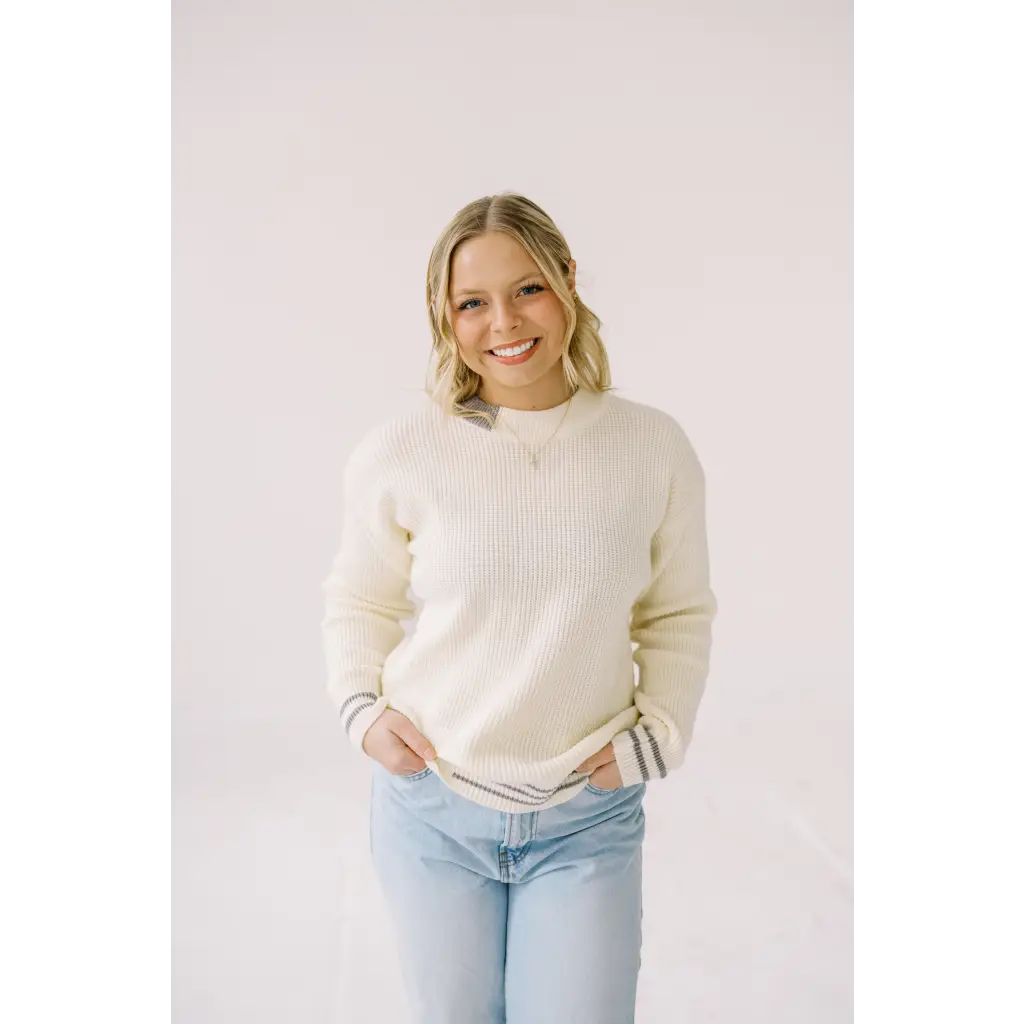 Cream-colored ribbed Sam Crew Neck sweater paired with light blue jeans for cozy vibes