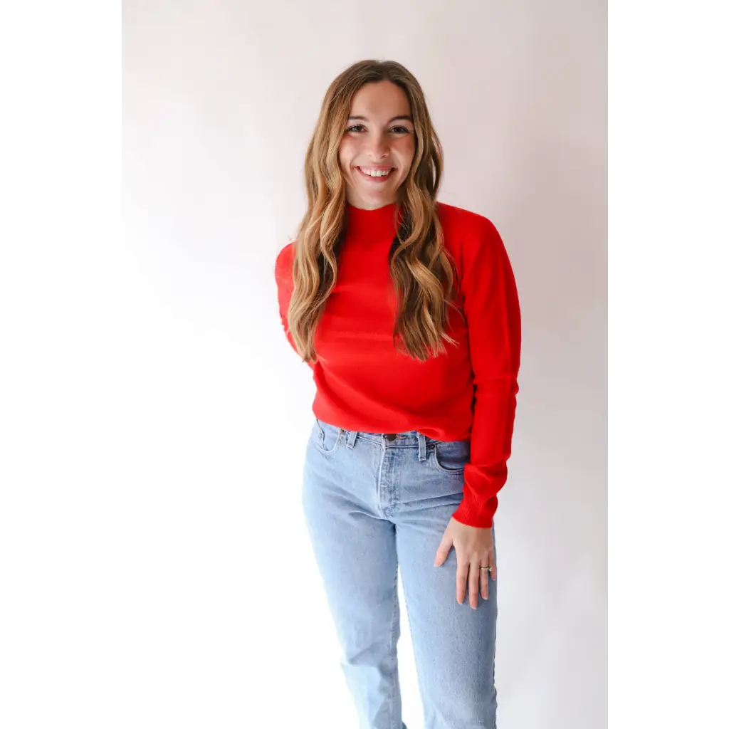 Person rocking the Sherry Sweater in Bright Red with light wash jeans for an everyday wardrobe