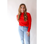 Person rocking the Sherry Sweater in Bright Red with light wash jeans for an everyday wardrobe