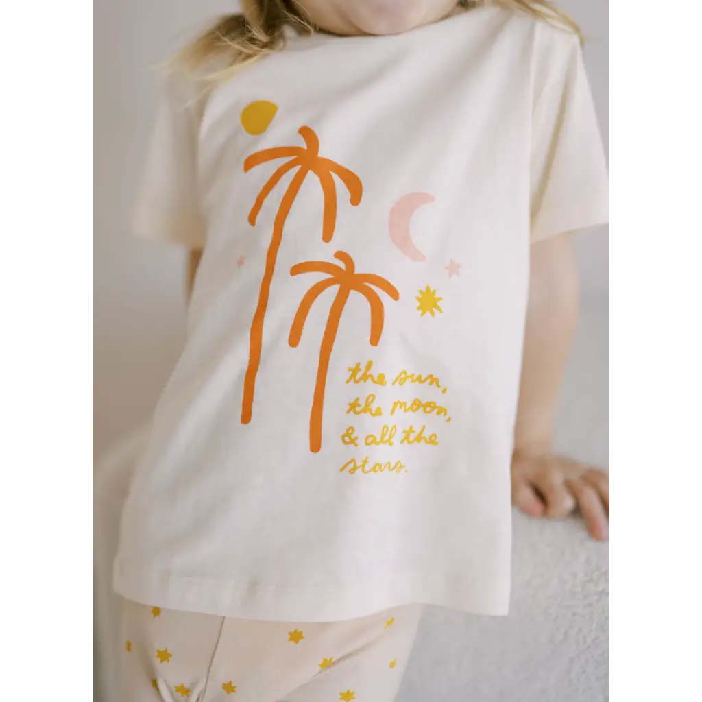 White T-shirt featuring orange palm trees and cool text design for sun moon vibes