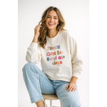 Cream-colored oversized sweatshirt with good ole days lettering on chest