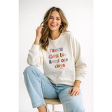 Cream-colored oversized sweatshirt with good ole days lettering on chest