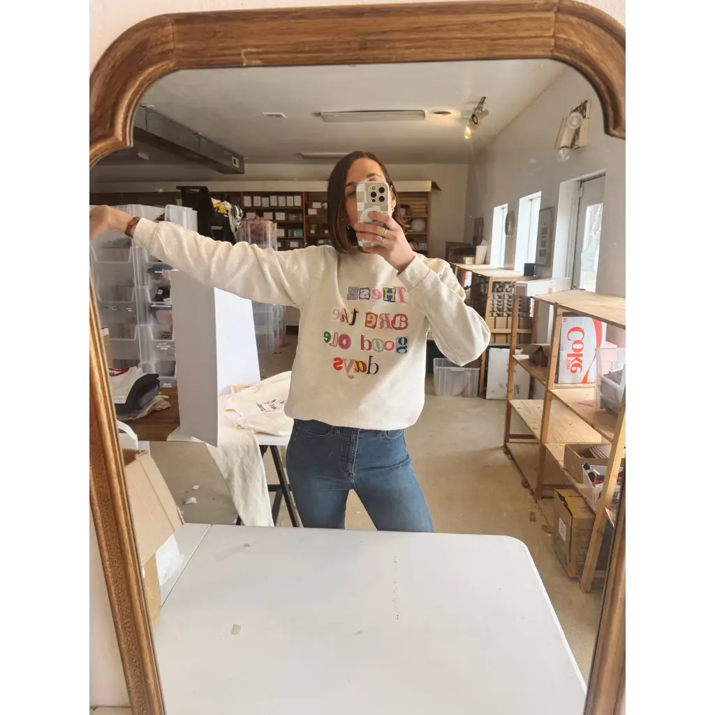 Cream-colored long-sleeved sweatshirt with good ole days reversed lettering